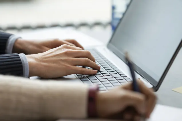 Laptop and hands. Photo.