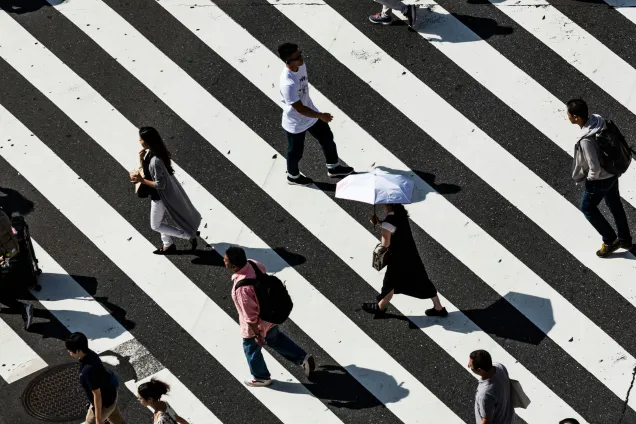 People walking on pedestrian lane. Photo by Ryoji Iwata on Unsplash. 